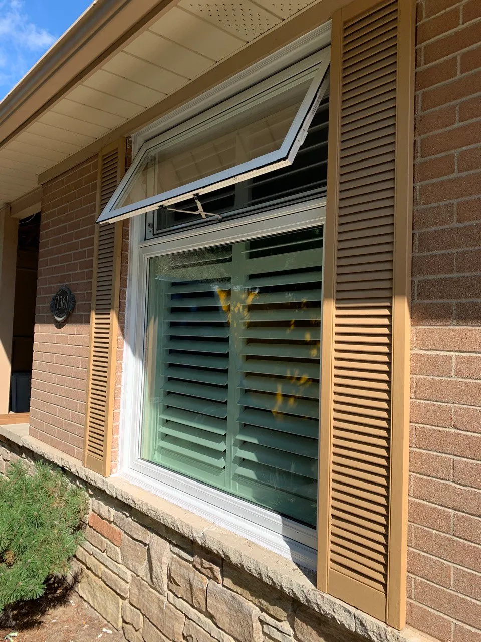 White-framed window with lower awning section open