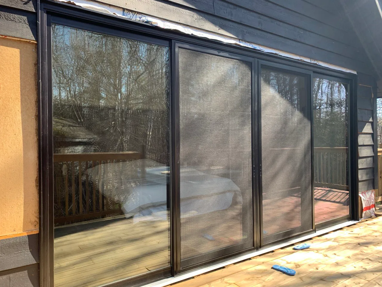 Wide black-framed multi-panel glazed door wall