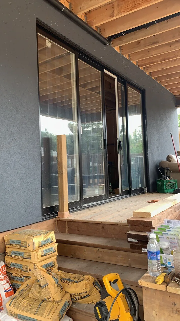 Black-framed multi-panel patio door during installation