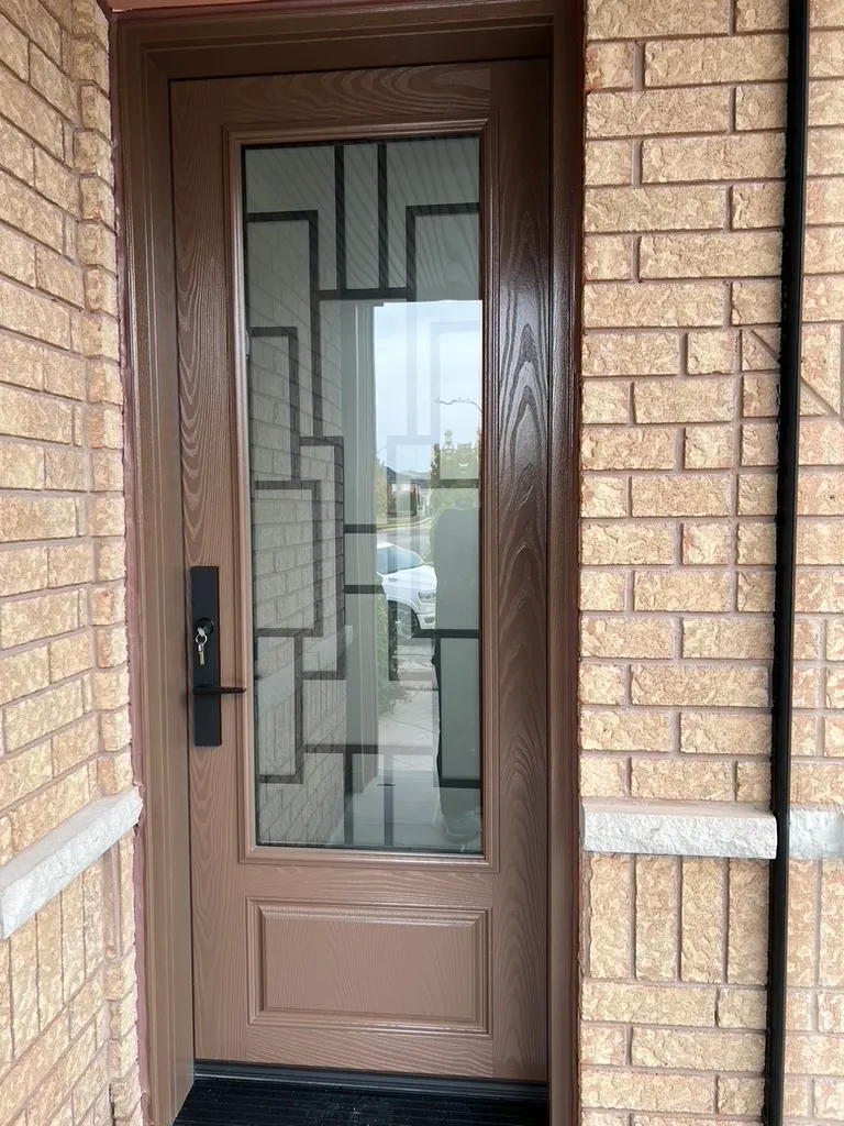Brown entry door with a decorative glass panel
