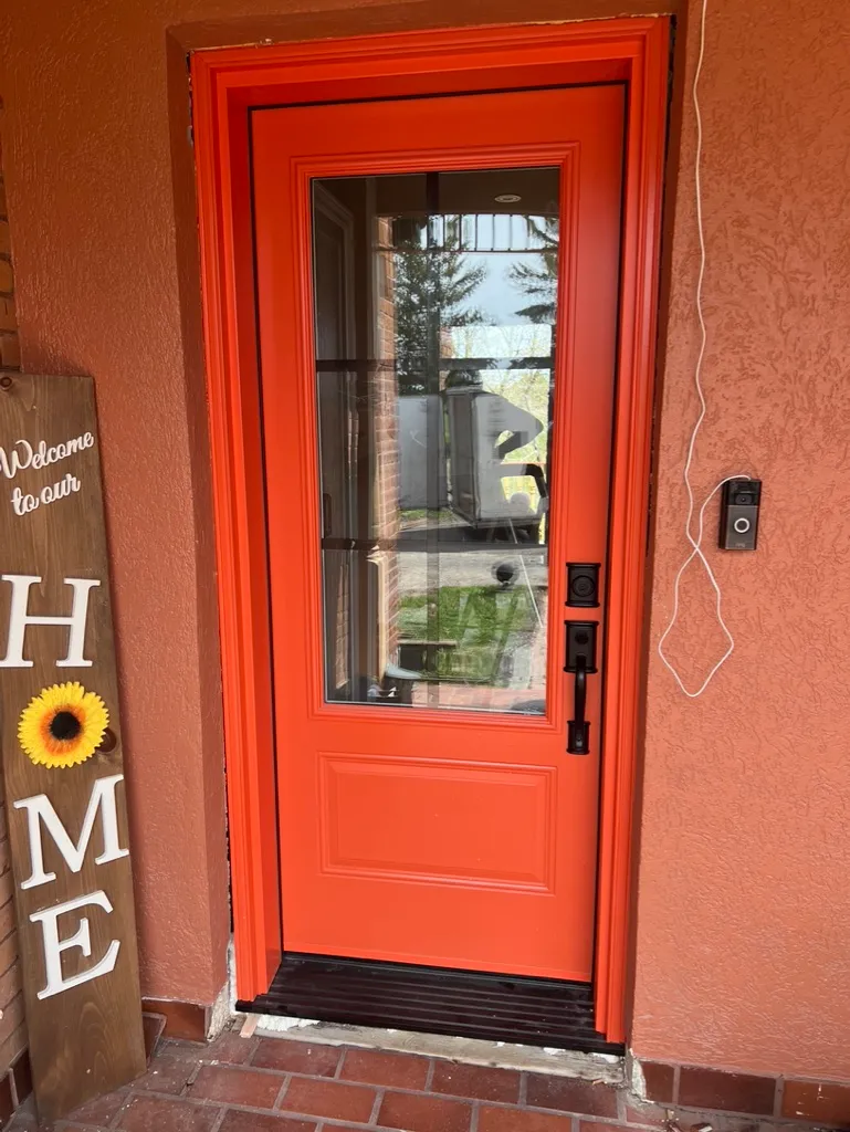 Red entry door with a large rectangular glass insert