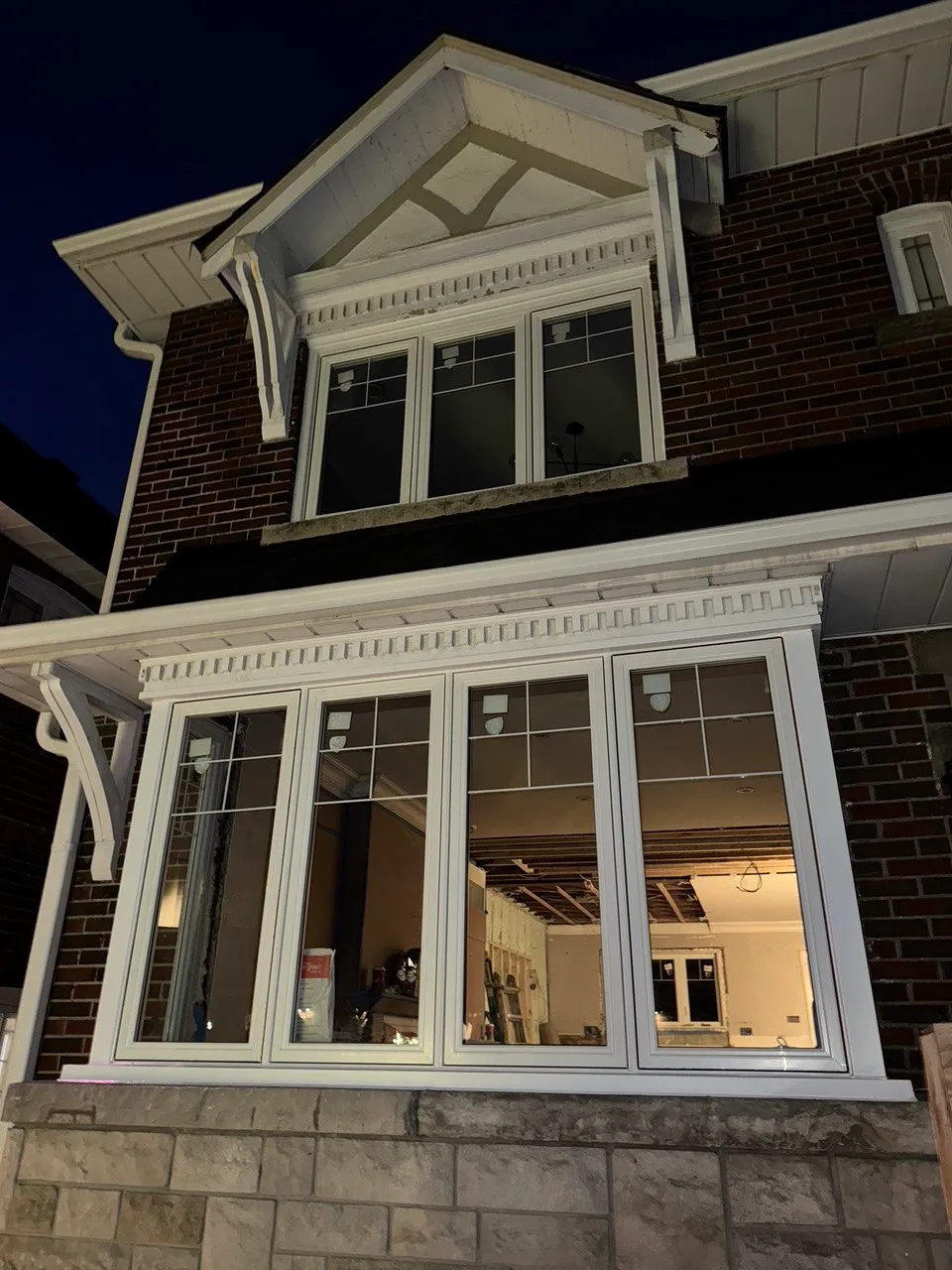 White multi-panel casement window combinations in a brick home