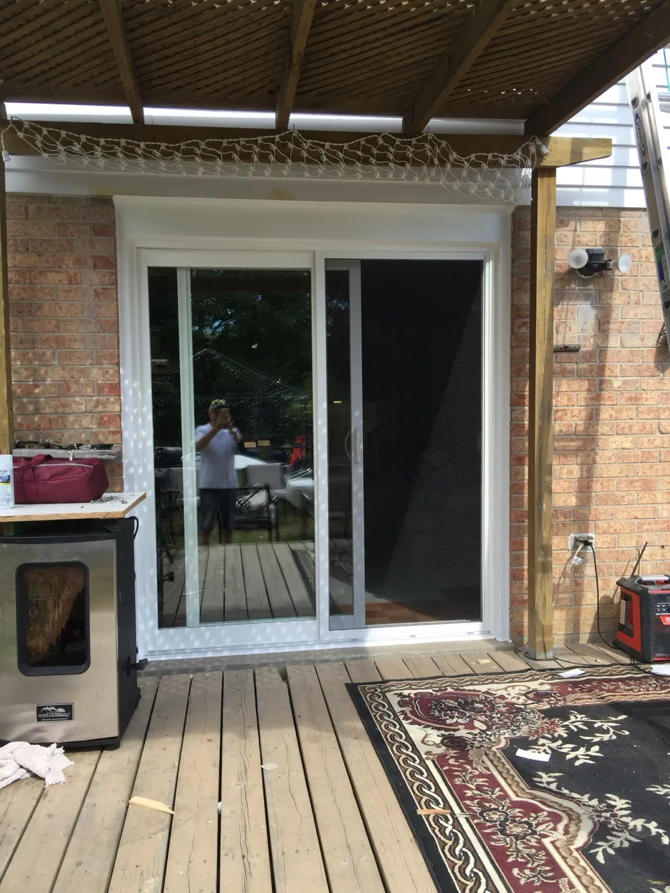 White-framed sliding patio door opening onto a covered deck