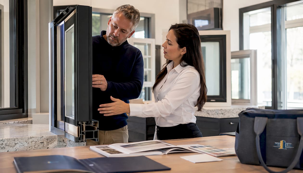 Homeowner consulting window provider in showroom