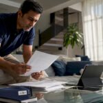 Man reviewing home renovation quote at kitchen table